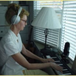 judy at work in her studio with headphones on.